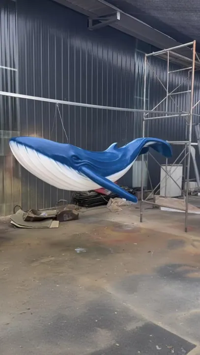 Blue whale sculpture suspended in the fabrication shop