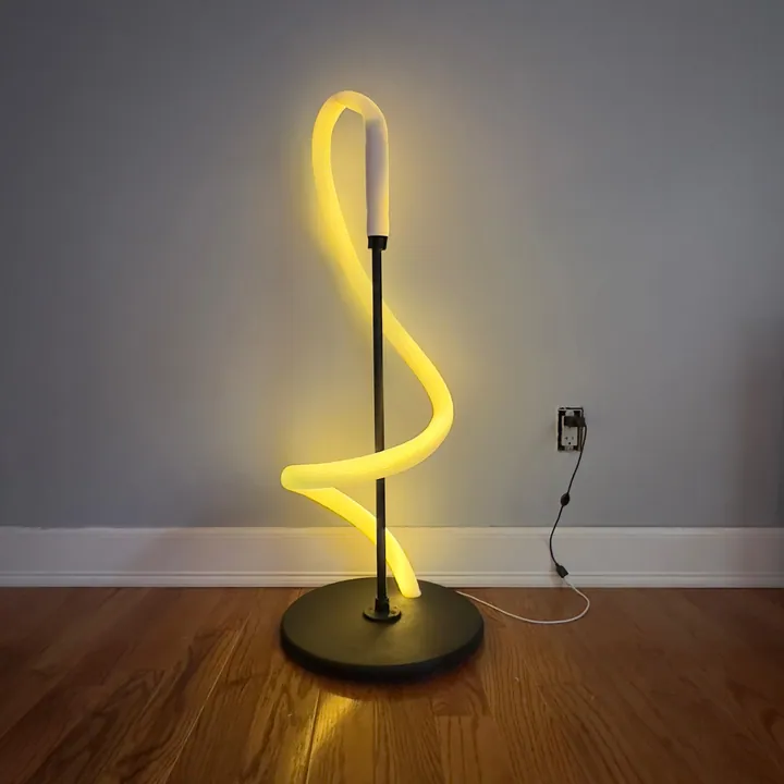 Flexible LED sculptural floor lamp twisting in a ribbon of warm light
