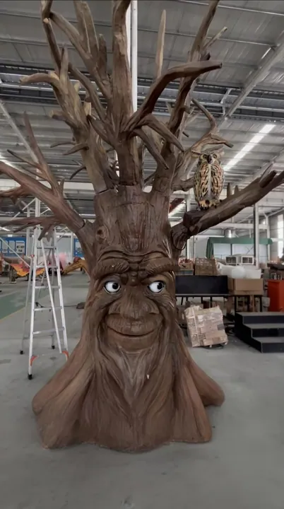 Large themed tree prop with a carved friendly face in the fabrication shop